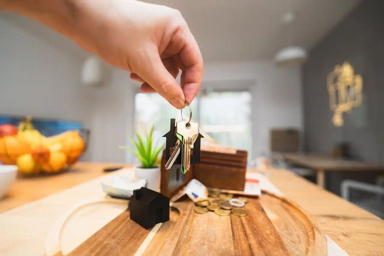 A person holding a key, symbolizing access to a new home.