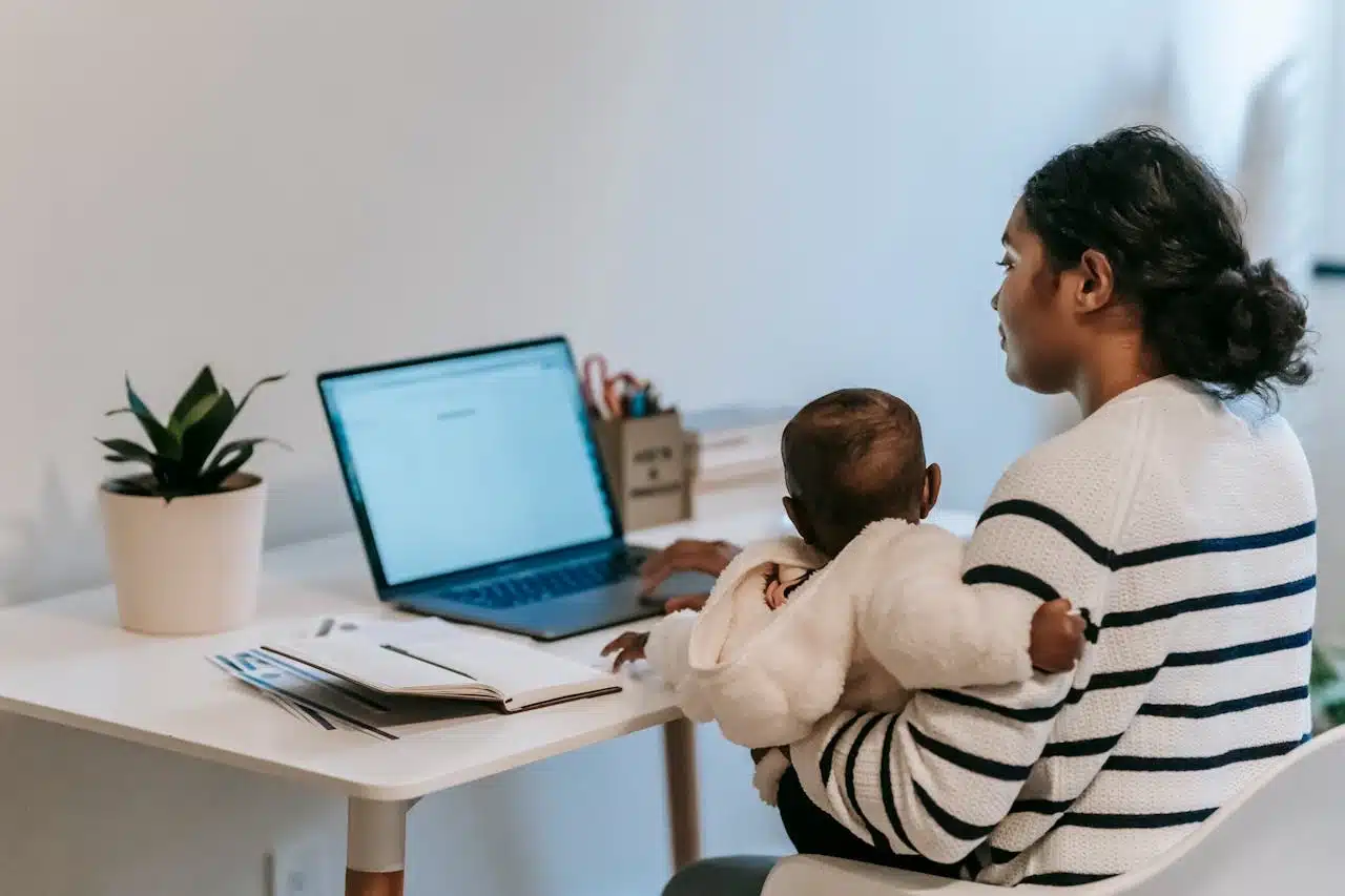 A woman analyzes data on a computer, focusing on graphs and charts displayed on the screen.