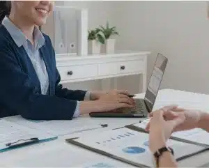 A woman in a business suit engages in conversation with another woman in a professional setting.