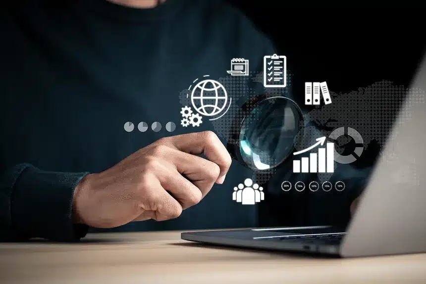 A man working on a laptop surrounded by various business icons representing finance, communication, and technology.