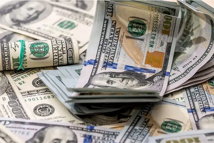 A pile of cash tied with a green ribbon, symbolizing wealth and celebration.