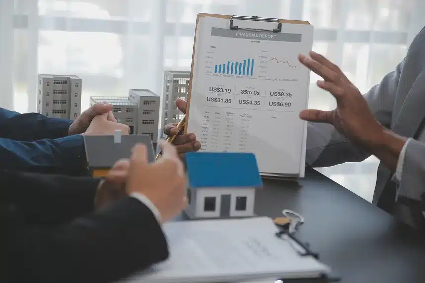 A man and woman examine a chart on a clipboard, discussing its details in a professional setting.