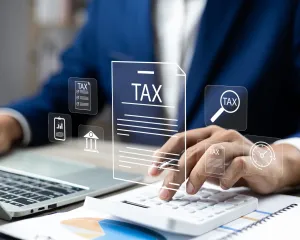 Tax return filing business concept, featuring documents, calculator, and financial tools on a desk, symbolizing tax preparation.