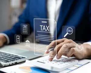 A stack of tax return documents, symbolizing the process of filing taxes and financial organization.