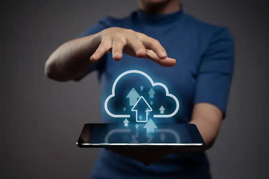 Woman holding a tablet displaying a cloud icon, representing the concept of cloud computing.