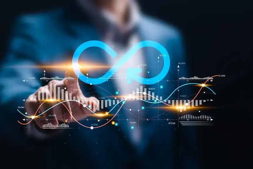 Businessman pointing to an infinity symbol against a dark background, symbolizing limitless possibilities and potential.