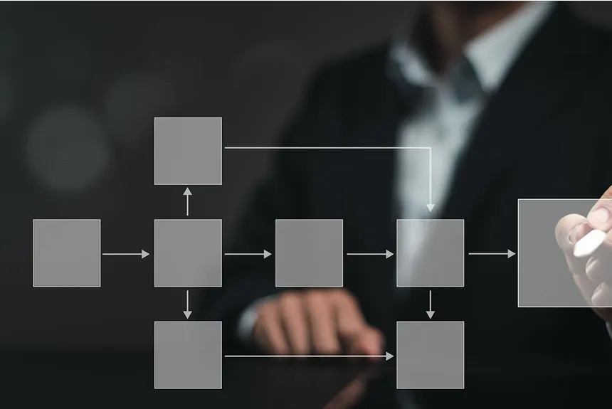 Businessman illustrating a business process diagram on a virtual screen, showcasing workflow and strategy development.