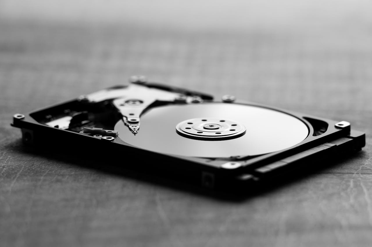 Black and white image of a hard drive, showcasing its metallic casing and internal components.